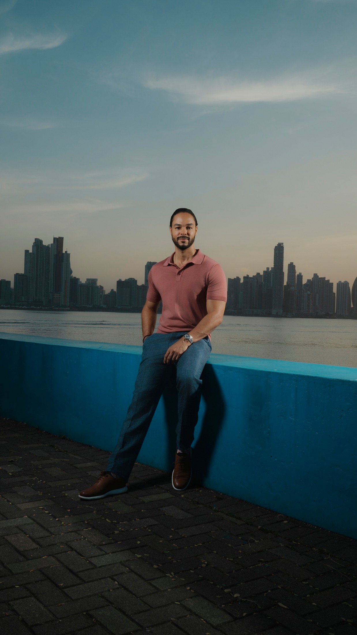 Ramón Aranha-Gericke seated beside the Panama City waterfront